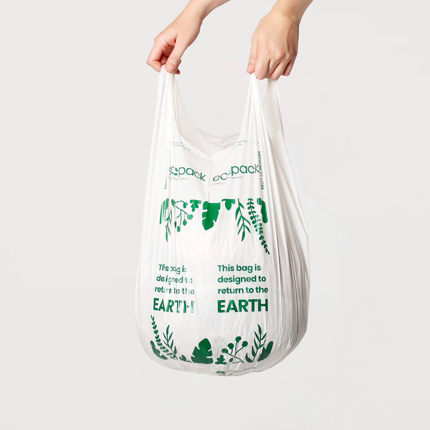 Hand holding a 27L compostable bin liner to show size