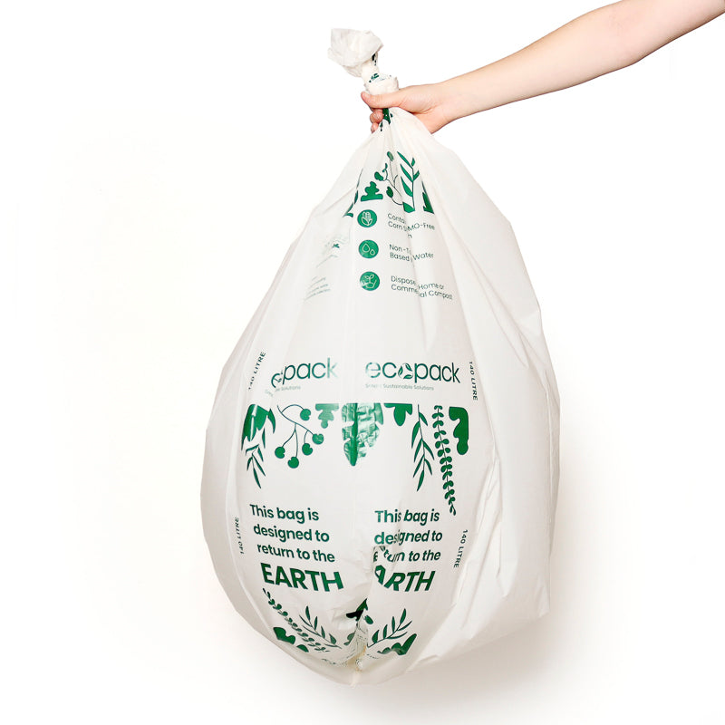 Hand holidng a compostable bin bag