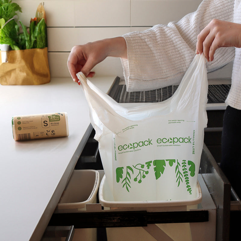 Small compostable bin liner in a kitchen bin with tie handles