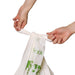 Hands tying the Compostable Bin Liners