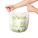 Hands on white compostable bin liner